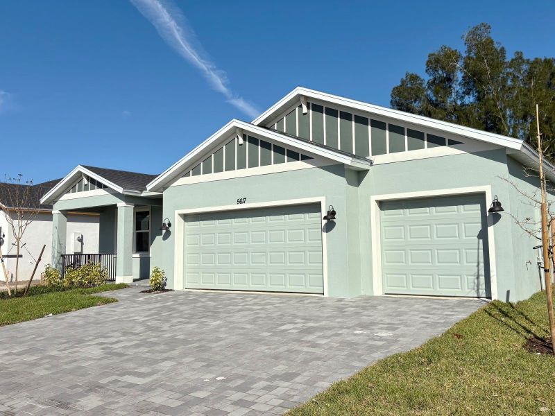Front exterior of a new home in Hampton Park - Signature Series, Vero Beach, FL, highlighting curb appeal (Image 10). Front exterior of a new home in Hampton Park - Signature Series, Vero Beach, FL, highlighting curb appeal (Image 10).