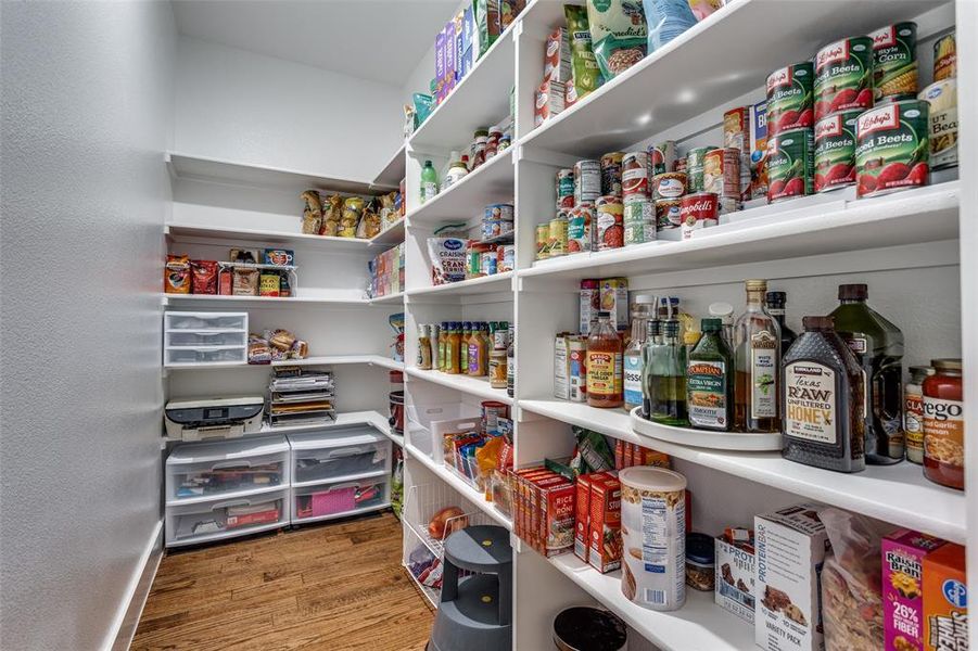 Oversized walk-in pantry offers ample space for kitchen gadgets and food storage