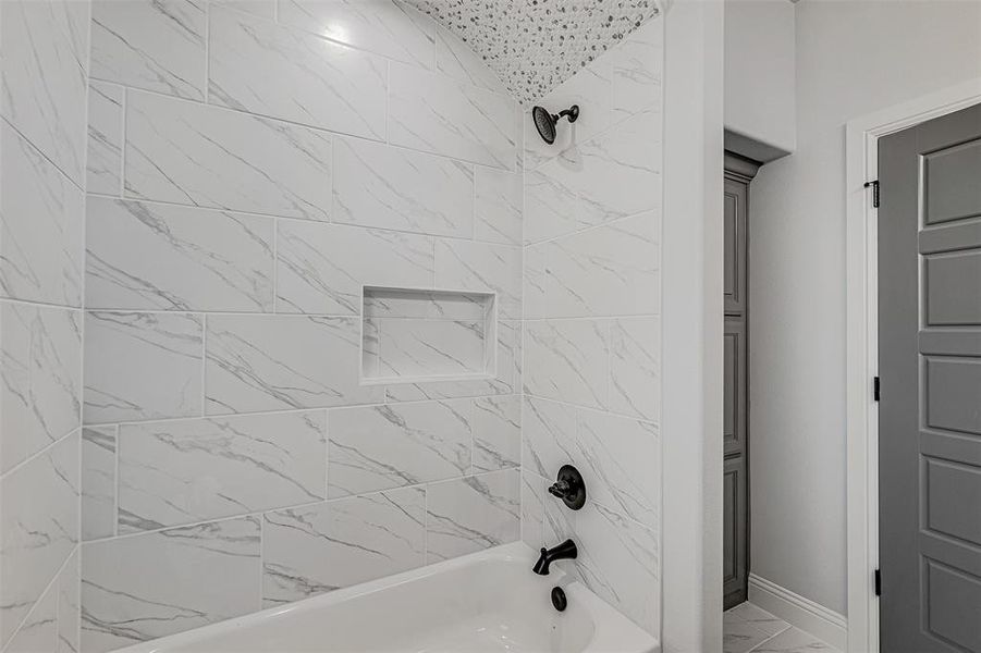 Bathroom featuring tiled shower / bath combo