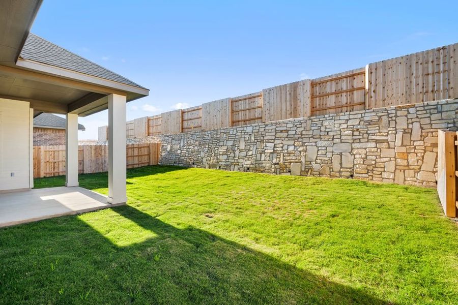 Exterior details and patio area of a home in Park Collection at Lariat, Liberty Hill (Image 24).