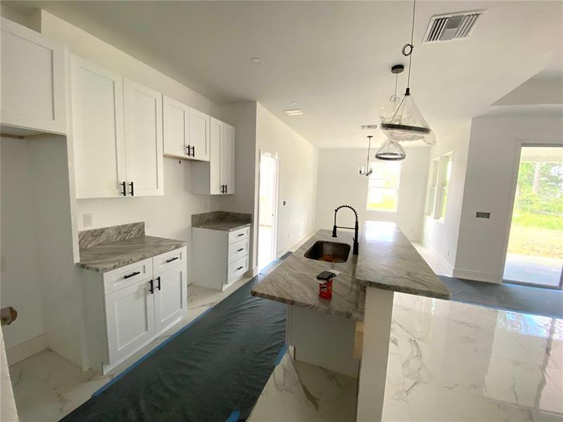 kitchen with island & hop up bar, dining room in the rear, granite counter tops, stainless appliances