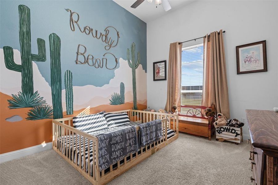 Carpeted bedroom featuring ceiling fan