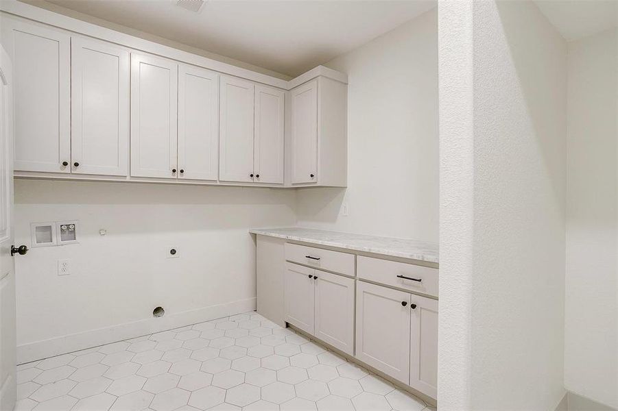 Laundry area with hookup for a washing machine, cabinets, hookup for a gas dryer, and hookup for an electric dryer