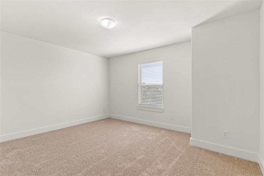 Spare room with baseboards and light colored carpet Spare room with baseboards and light colored carpet