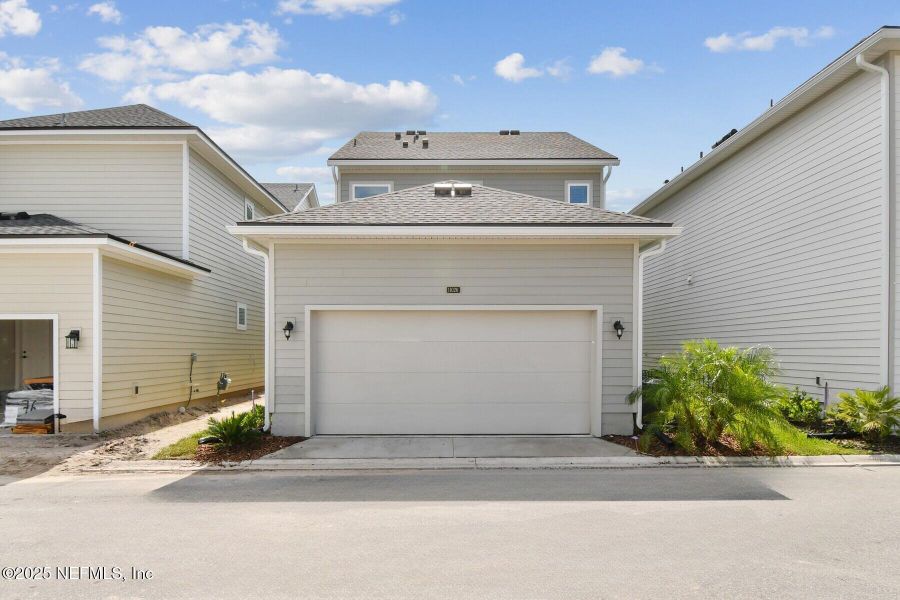 Front exterior of a new home in Granville at eTown 34', Jacksonville, FL, highlighting curb appeal (Image 20).
