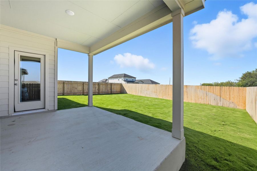 Fenced backyard with a patio area Fenced backyard with a patio area