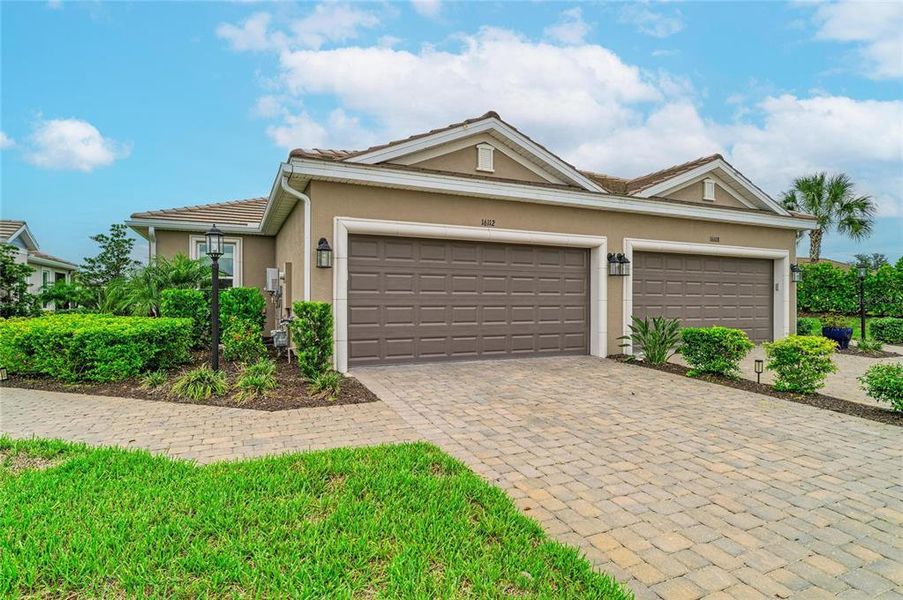 Front exterior of a new home in Esplanade at Azario Lakewood Ranch, Lakewood Ranch, FL, highlighting curb appeal (Image 2). Front exterior of a new home in Esplanade at Azario Lakewood Ranch, Lakewood Ranch, FL, highlighting curb appeal (Image 2).