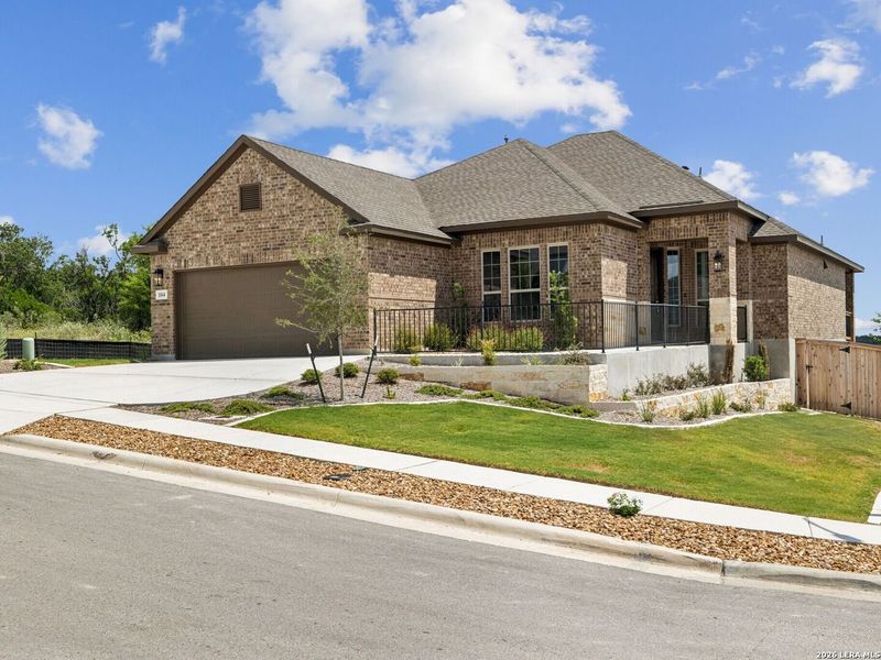 Front exterior of a new home in Cibolo Crossing, Universal City, TX, highlighting curb appeal (Image 2).
