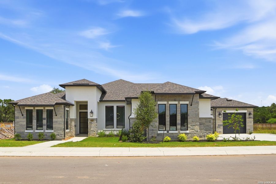 Front exterior of a new home in Shavano Highlands, San Antonio, TX, highlighting curb appeal (Image 2). Front exterior of a new home in Shavano Highlands, San Antonio, TX, highlighting curb appeal (Image 2).