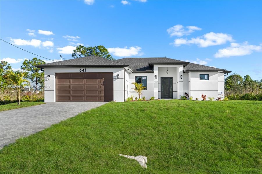Front exterior of a new home in , Lehigh Acres, FL, highlighting curb appeal (Image 21).