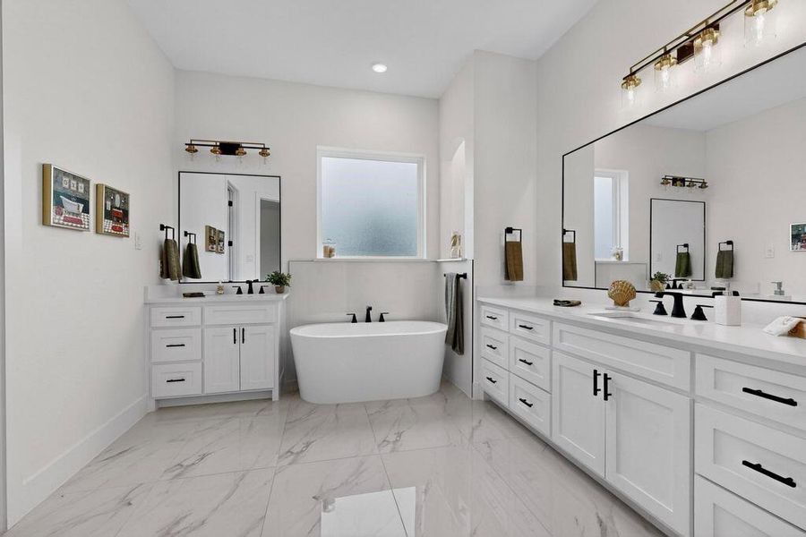 Full bath with two vanities, a freestanding bath, light marble finish floors, and recessed lighting Full bath with two vanities, a freestanding bath, light marble finish floors, and recessed lighting