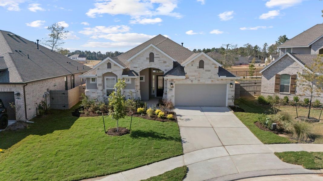 Front exterior of a new home in Artavia, Conroe, TX, highlighting curb appeal (Image 18).