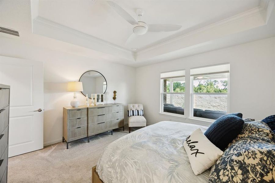 Another view of the primary showing the view out back. The property is bordered by a stone wall that add to the privacy of the back of the home including the bedroom.