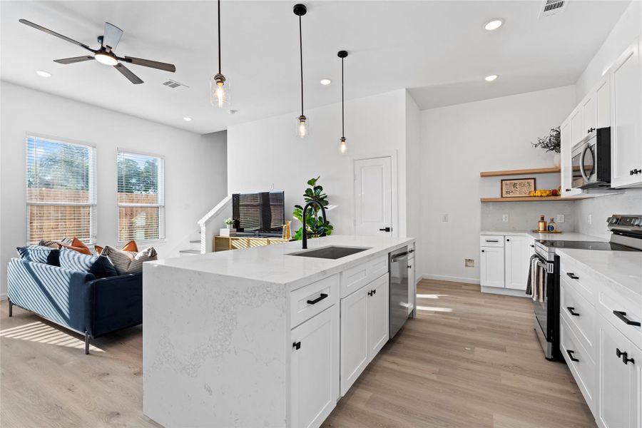 Kitchen and living stay visually connected, so cooking, homework, and hangouts all happen in one easy space. Kitchen and living stay visually connected, so cooking, homework, and hangouts all happen in one easy space.