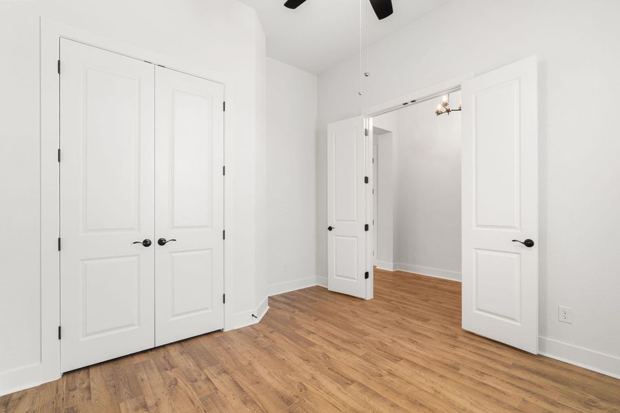 Hardwood-style flooring extends throughout this versatile space, ready for personalization.
