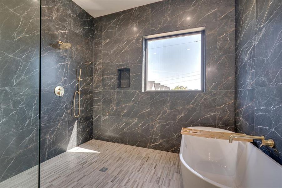 Bathroom featuring tile walls, sink, and separate shower and tub