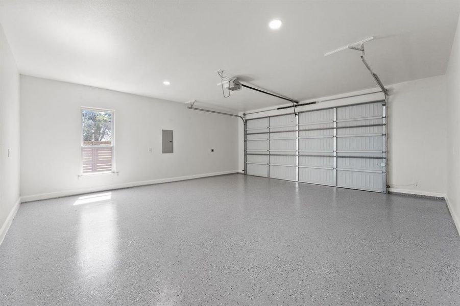 Garage featuring recessed lighting and electric panel