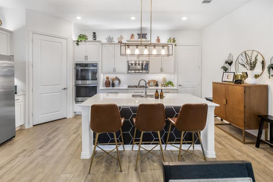 Kitchen featuring backsplash, appliances with stainless steel finishes, white cabinets, and recessed lighting Kitchen featuring backsplash, appliances with stainless steel finishes, white cabinets, and recessed lighting
