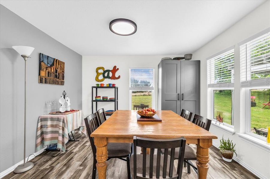 Dining area featuring light wood-type flooring and baseboards