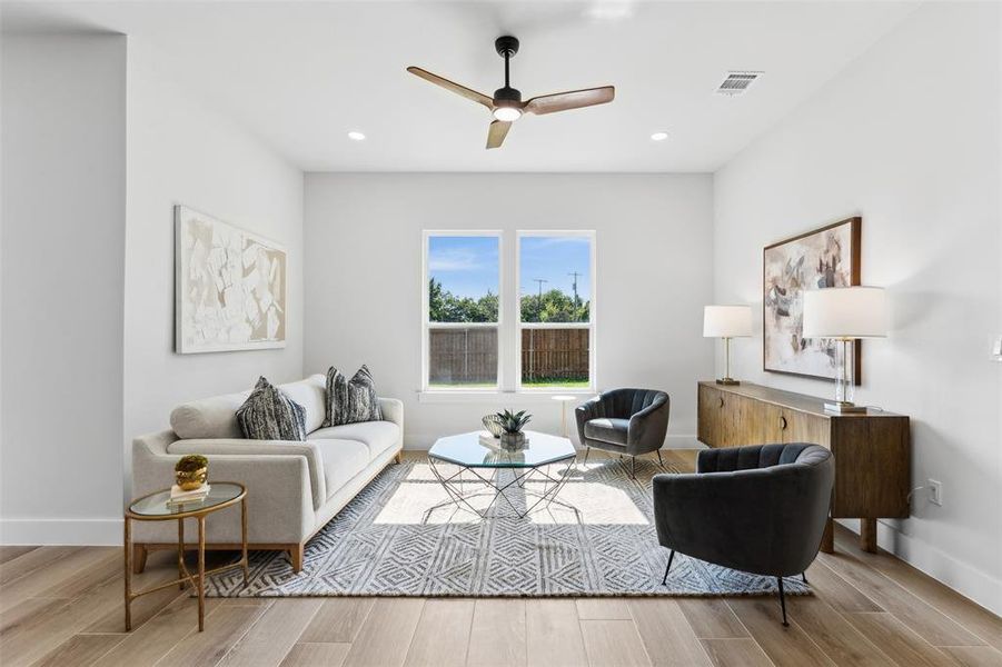 Living room featuring light wood-type flooring and ceiling fan