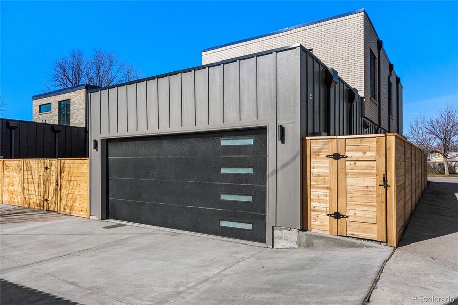 The attached 2-car garage is finished with textured and painted walls.