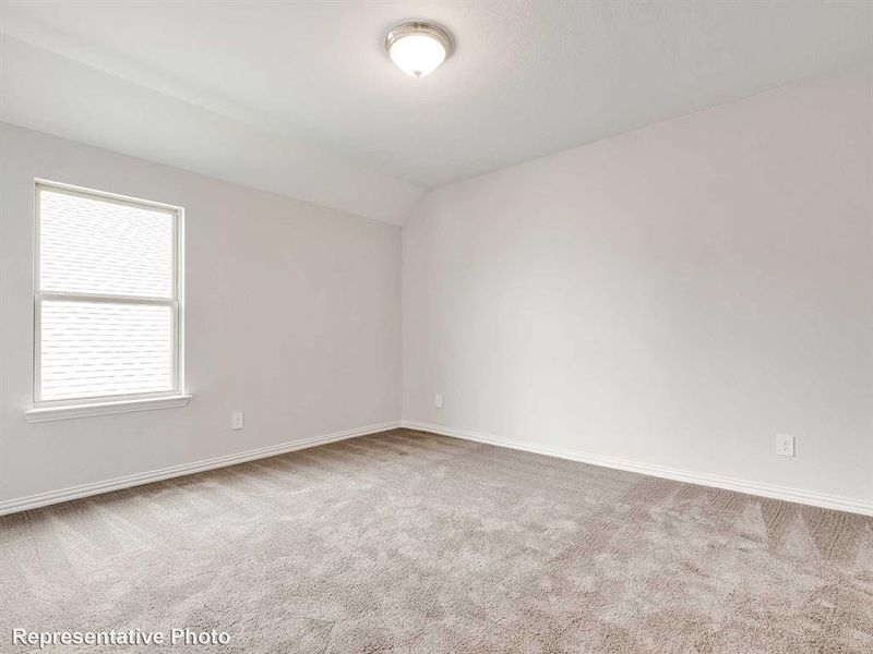 This room features a window providing natural light, light-colored walls, and carpeting