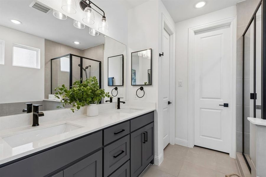 Clean lines, designer fixtures, and abundant storage create a bright, modern space that elevates the daily routine.