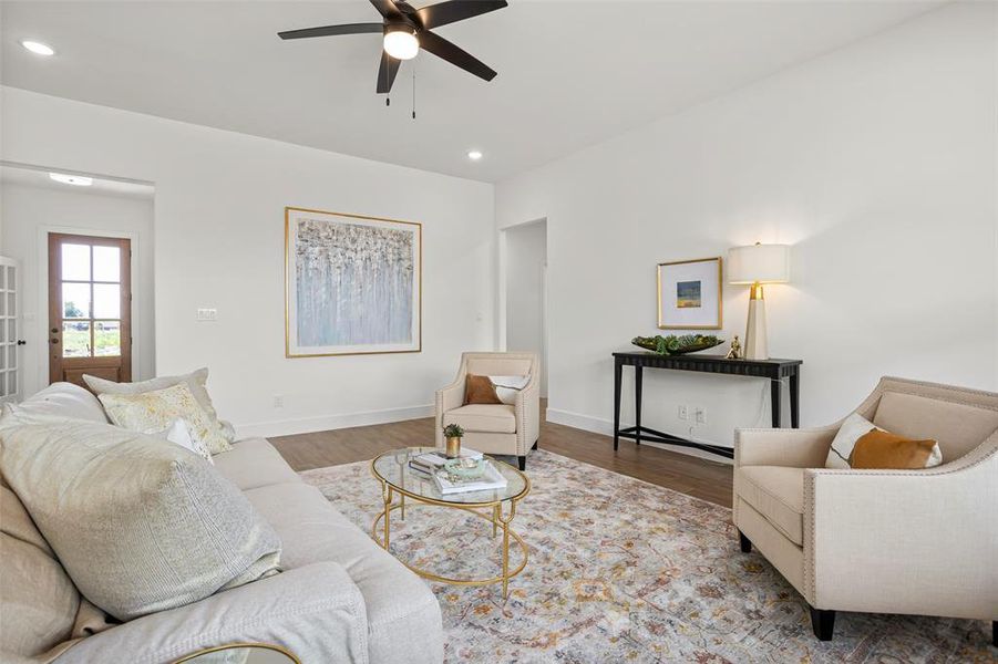 Living room featuring ceiling fan and hardwood / wood-style floors