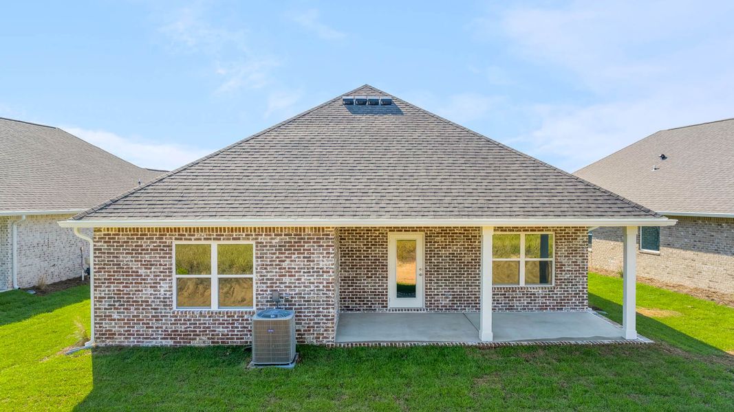 Front exterior of a new home in Owl's Head Farms, Freeport, FL, highlighting curb appeal (Image 14). Front exterior of a new home in Owl's Head Farms, Freeport, FL, highlighting curb appeal (Image 14).