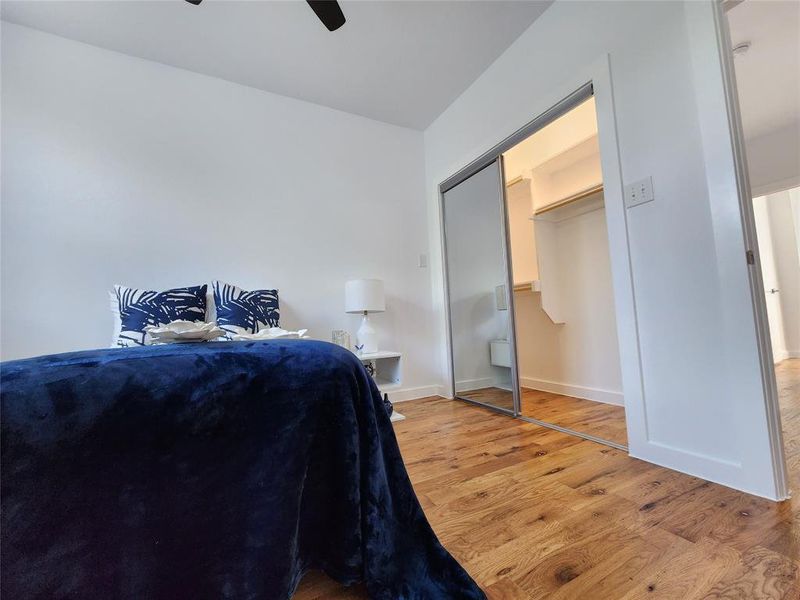 Bedroom featuring ceiling fan, a closet, and light hardwood / wood-style flooring