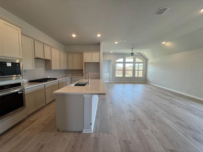Kitchen featuring appliances with stainless steel finishes, a ceiling fan, light countertops, recessed lighting, and an island with sink Kitchen featuring appliances with stainless steel finishes, a ceiling fan, light countertops, recessed lighting, and an island with sink