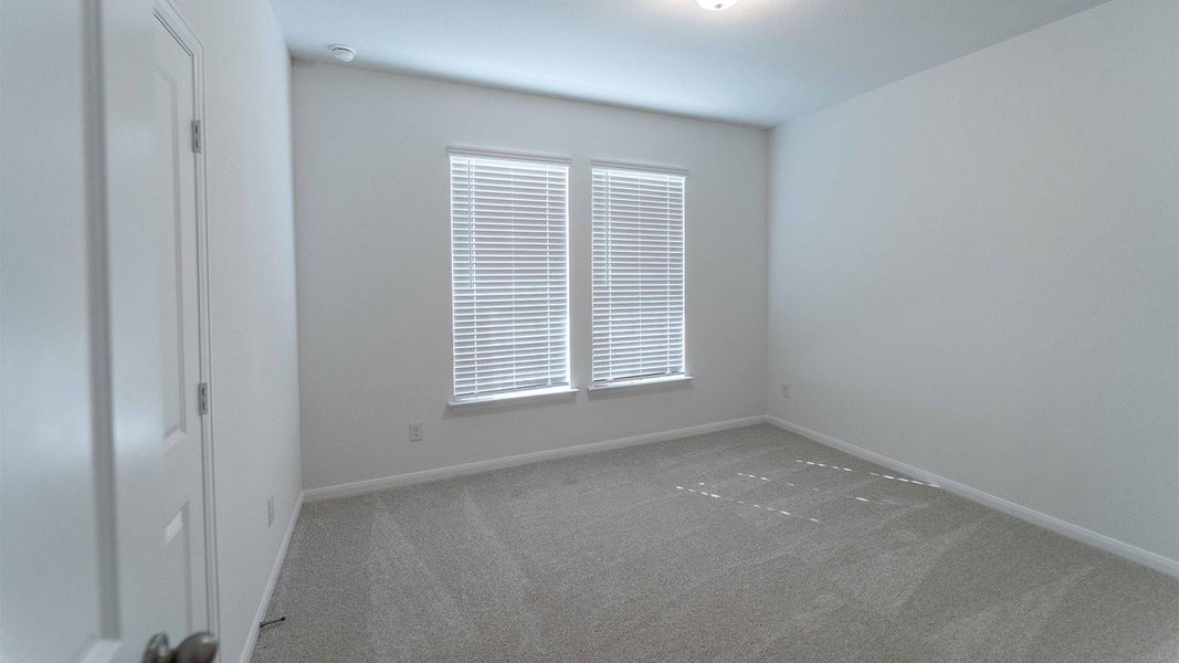 Unfurnished room with carpet and baseboards
