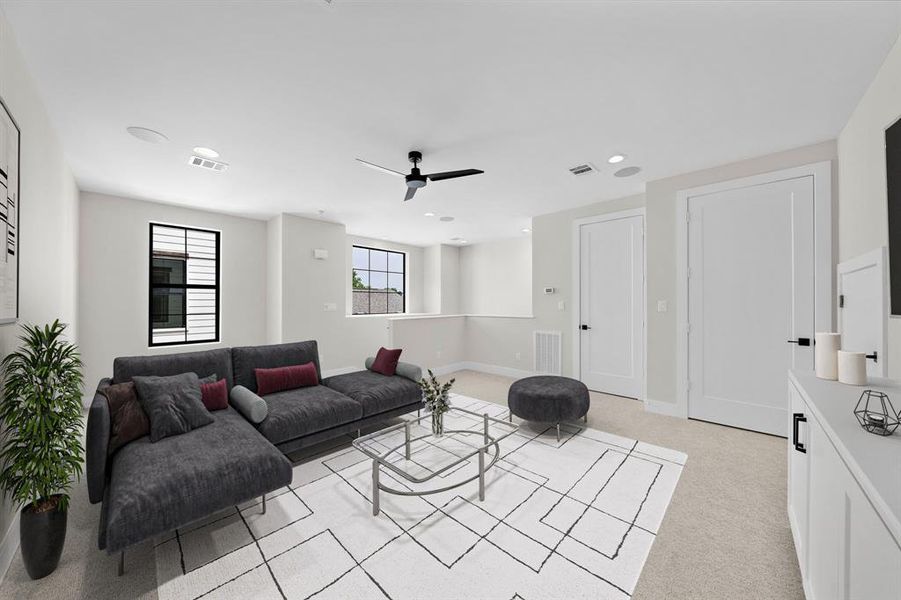 Ascend to the third floor game / media room with ceiling speakers and storage. Furniture shown in photo is virtually staged.