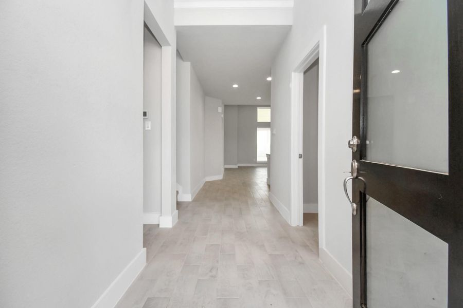 Indulge in luxury as you step into the threshold of this breathtaking home. The grand entrance beckons with its soaring ceilings, adorned with elegant lwood-look tile flooring & sleek oversized baseboards. Follow the path of natural light streaming through expansive windows as you make your way to the family room, creating an inviting and warm atmosphere. Sample photo of completed home with similar floor plan. Actual colors and selections may vary. Indulge in luxury as you step into the threshold of this breathtaking home. The grand entrance beckons with its soaring ceilings, adorned with elegant lwood-look tile flooring & sleek oversized baseboards. Follow the path of natural light streaming through expansive windows as you make your way to the family room, creating an inviting and warm atmosphere. Sample photo of completed home with similar floor plan. Actual colors and selections may vary.