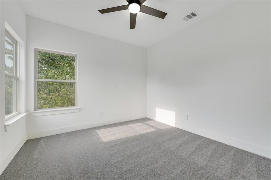 Unfurnished room featuring carpet and ceiling fan Unfurnished room featuring carpet and ceiling fan