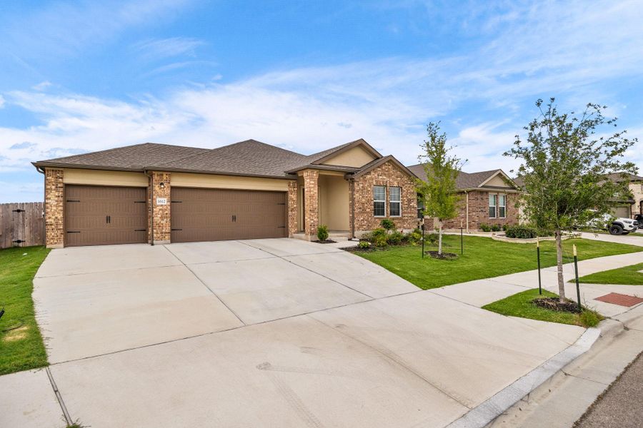 A well-maintained lawn and sturdy brick exterior create inviting curb appeal.