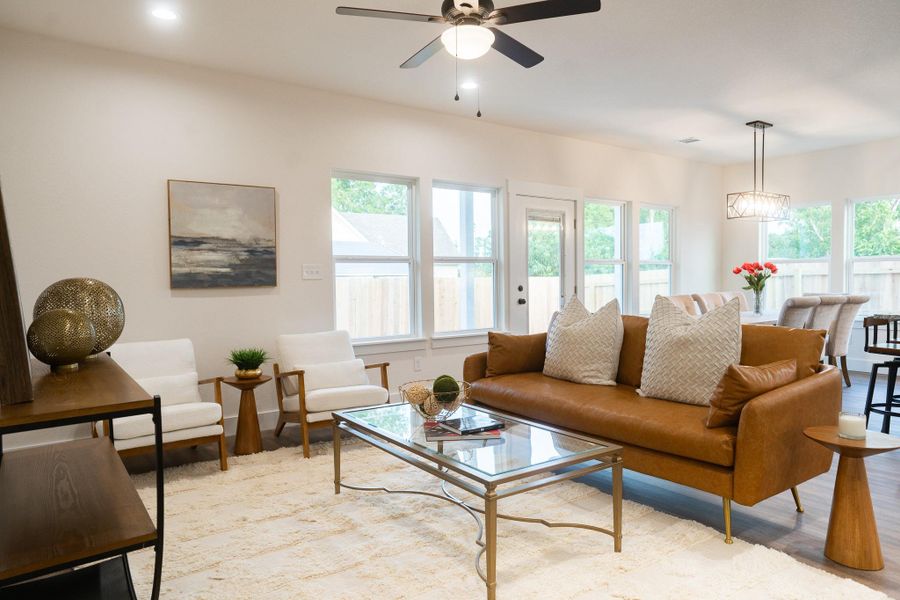 Living area featuring a ceiling fan, light wood-type flooring, and recessed lighting