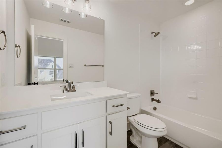 White vanity with an integrated sink, brushed nickel faucet, and coordinating hardware White vanity with an integrated sink, brushed nickel faucet, and coordinating hardware