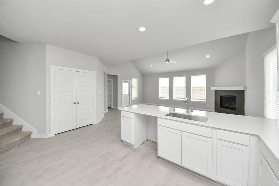 All of this overlooks your expansive family room, creating a perfect space for culinary delights and family gatherings. Sample photo of completed home with similar floor plan. Actual colors and selections may vary. All of this overlooks your expansive family room, creating a perfect space for culinary delights and family gatherings. Sample photo of completed home with similar floor plan. Actual colors and selections may vary.