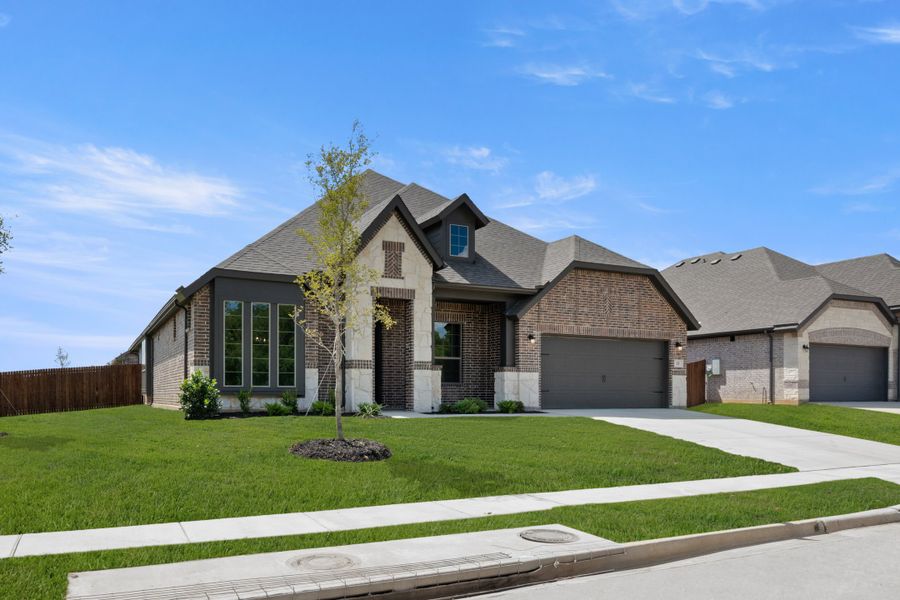 Front exterior of a new home in Mockingbird Hills - Signature Series, Joshua, TX, highlighting curb appeal (Image 2). Front exterior of a new home in Mockingbird Hills - Signature Series, Joshua, TX, highlighting curb appeal (Image 2).
