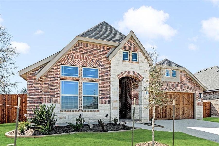 Front exterior of a new home in The Oaks, Red Oak, TX, highlighting curb appeal (Image 2).