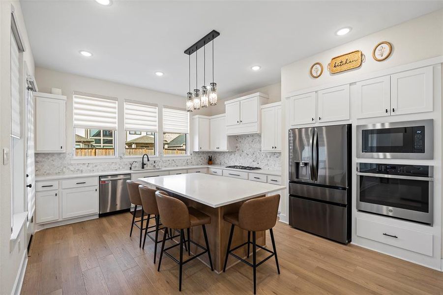 The kitchen is a cook's delight with ample counter space and plenty of cabinets, and KitchenAid Profile appliances.