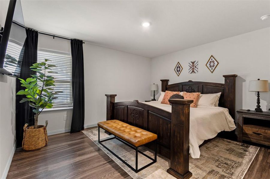 Primary Bedroom with wood finished floors