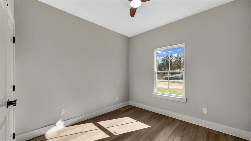Empty room featuring wood finished floors and ceiling fan