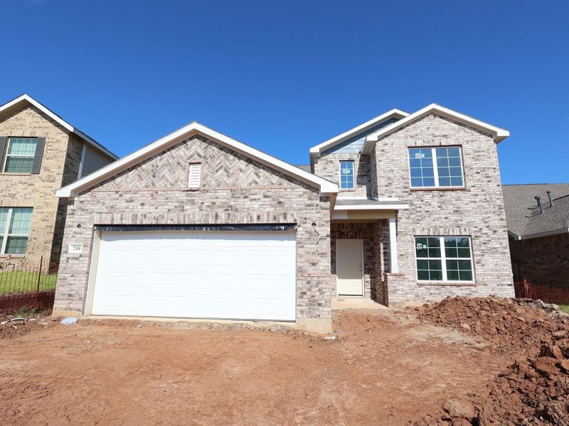 Front exterior of a new home in Magnolia Ridge, Magnolia, TX, highlighting curb appeal (Image 2). Front exterior of a new home in Magnolia Ridge, Magnolia, TX, highlighting curb appeal (Image 2).