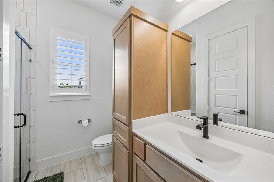Bathroom featuring vanity and a stall shower