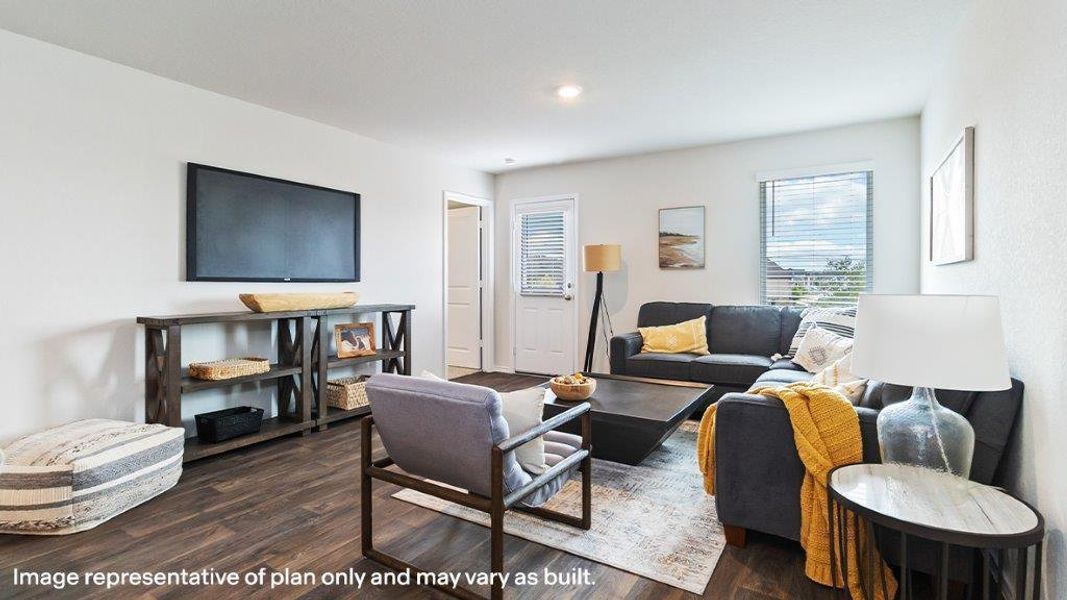 Rich hardwood-style flooring extends throughout this well-lit living space, offering both durability and charm. Rich hardwood-style flooring extends throughout this well-lit living space, offering both durability and charm.