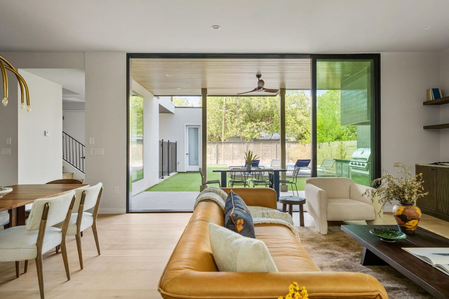 Retractable glass walls merge the main living area with a covered patio and private backyard. Retractable glass walls merge the main living area with a covered patio and private backyard.