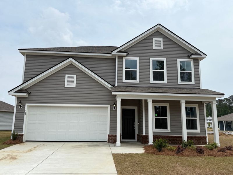 Front exterior of a new home in Solserra, Shallotte, NC, highlighting curb appeal (Image 17).