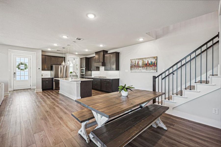 Open Dining area with light LVP flooring